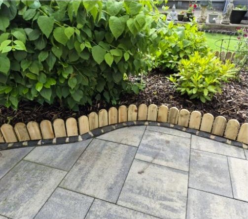 Wooden lawn edging used along a curved flower bed